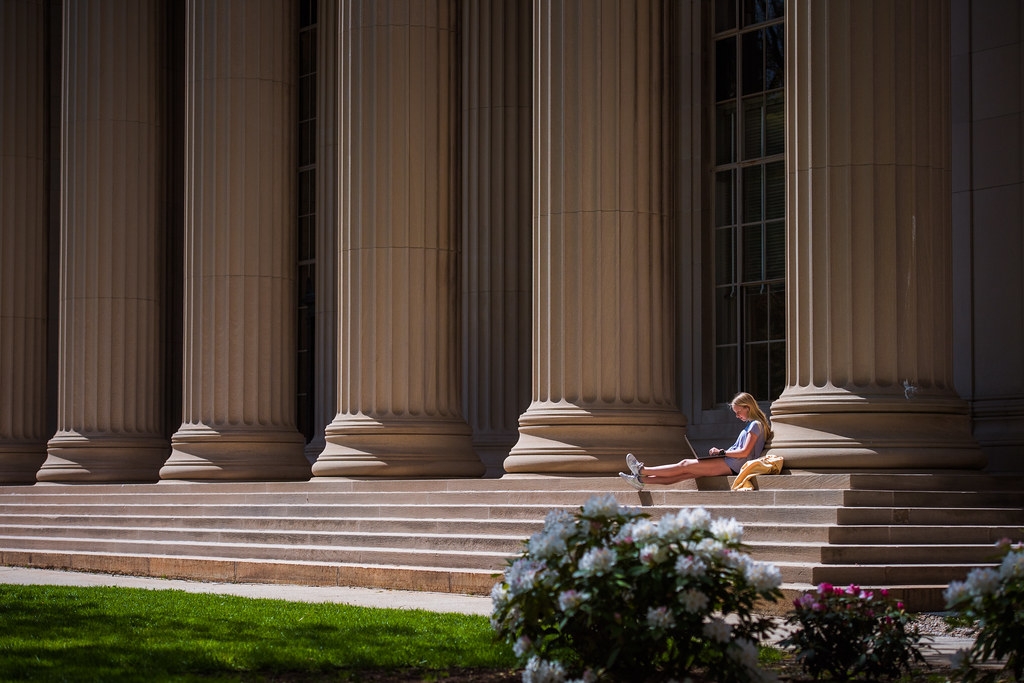 A student rests against a column outside Building 10, where the Great Dome is. A student rests against a column outside Building 10, where the Great Dome is. Photo by Gretchen Ertl