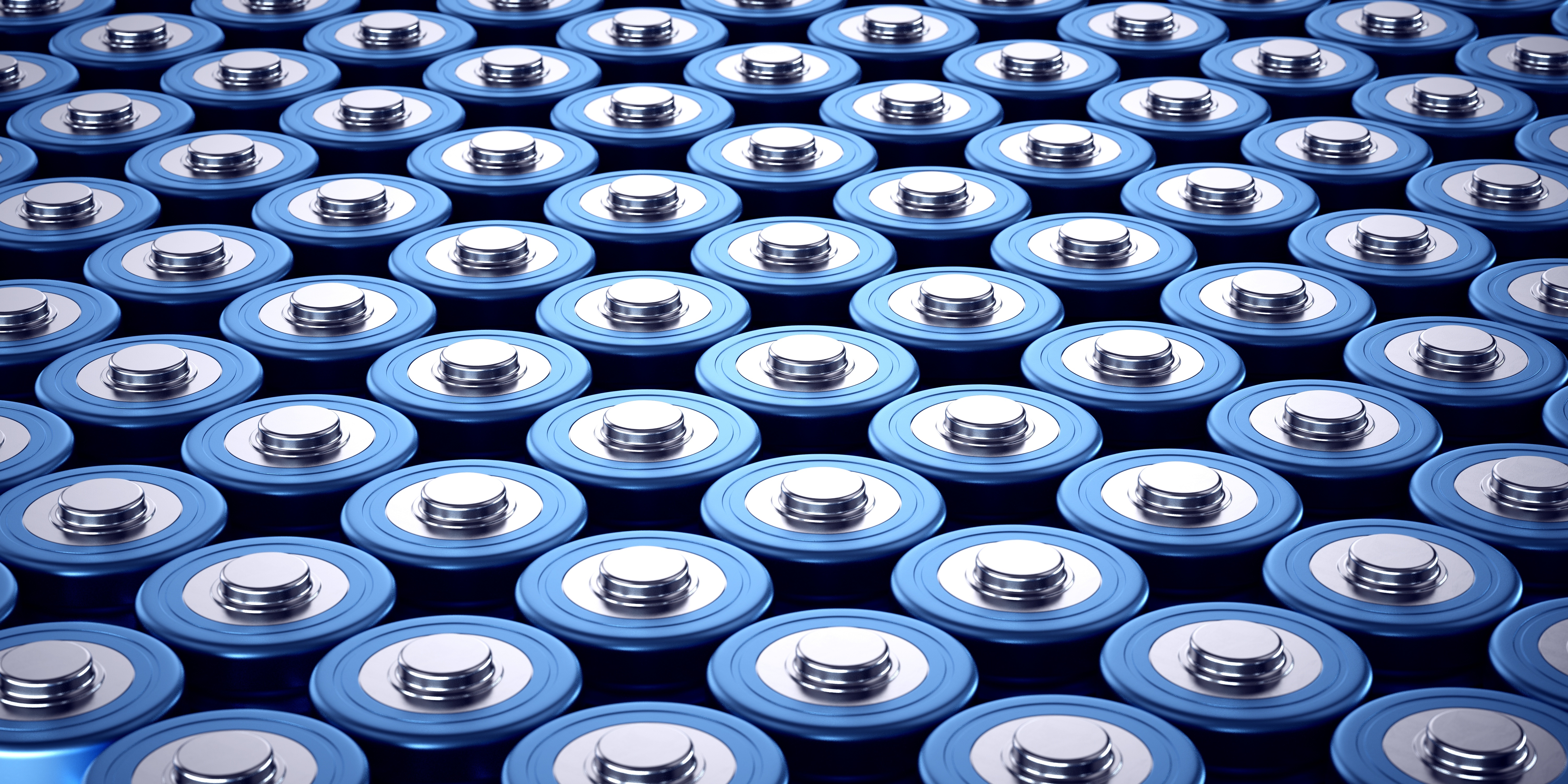 An array of blue batteries clustered together shown from the front and above. (Image: Adobe Stock, edited by MIT ISN)