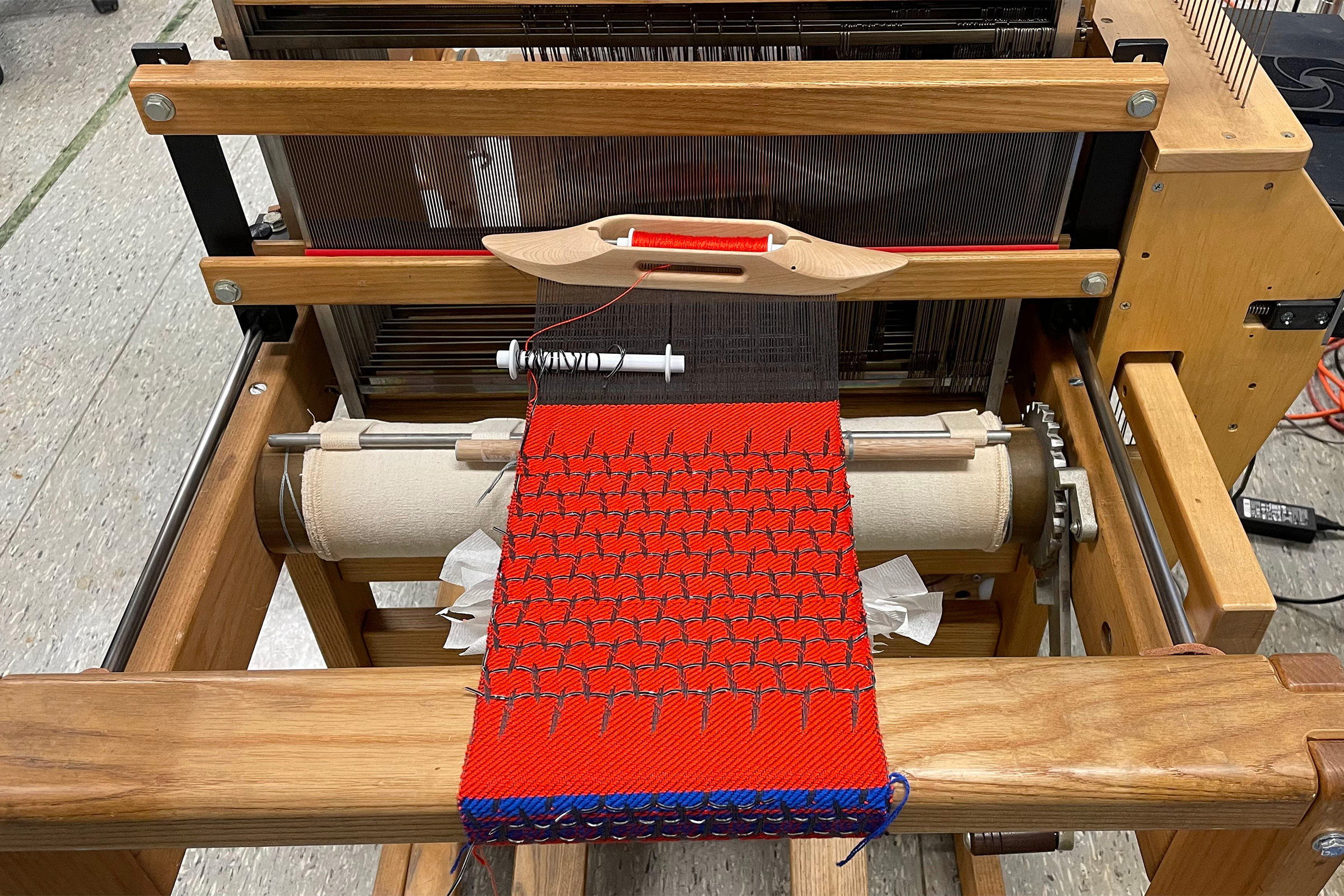 A fabric is woven on a loom