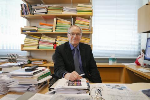 Prof. John Joannopoulos seated at the desk in his MIT ISN office. Photo: Jose-Luis Olivares, MIT