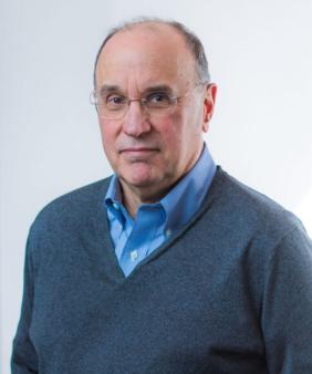 Prof. Michael J. Cima stands in front of a blurred wall