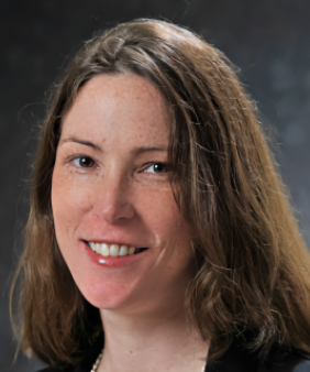 A woman's head in front of a blurred grey bacground