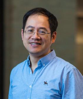 Prof. Ju Li in front of blurred doorways and windows